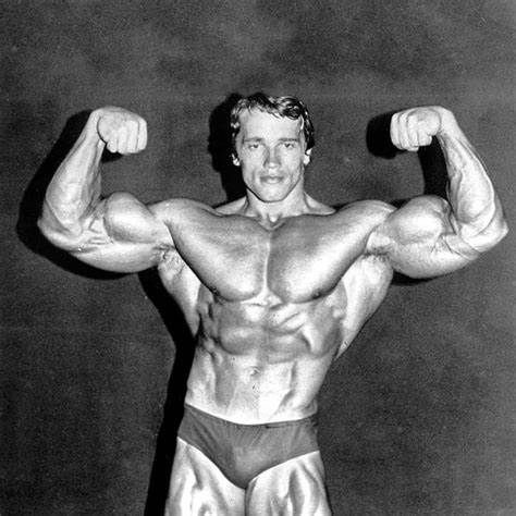 Arnold Schwarzenegger posing in black and white image.